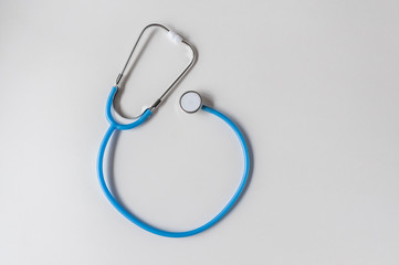 Blue stethoscope on white background. Copy space. Healthcare. World Health Day.