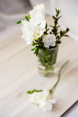 white freesia flowers in a glass