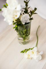 white freesia flowers in a glass