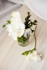white freesia flowers in a glass