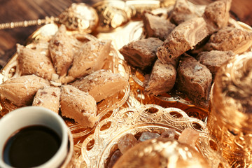 Turkish sweets with coffee on a wooden table