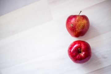 two red apples on a light background