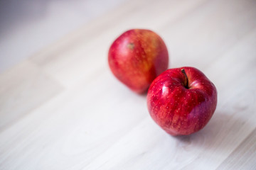 two red apples on a light background