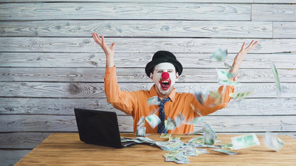 clown businessman with money in his hand. Concept on big boss with money.
