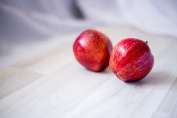 two red apples on a light background