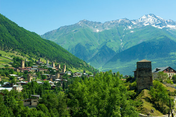 Landscape of Svaneti region, Georgia. Svan towers in Mestia mountain village, hills and high mountains on background