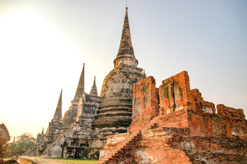 Fototapeta premium Ruin of Wat Mahathat in Ayutthaya, Thailand. Landmark Historical temple in Thailand with sunset twilight.