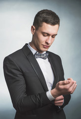 Beautiful fashion man in a suit and a butterfly