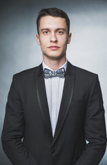 Beautiful fashion man in a suit and a butterfly