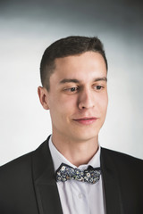 Beautiful fashion man in a suit and a butterfly