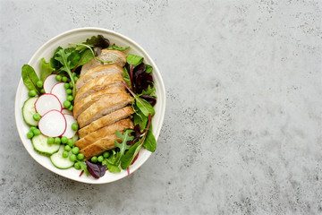 Baked turkey with salad and vegetables. Gray background, top view