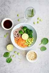 Vegan bowl of noodles, broccoli, edamame and carrots. Poke or buddha bowl. Clean eating  food concept