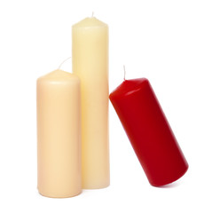 Colored candles of different size on white background