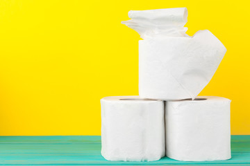 Toilet paper stacks  on bright yellow background