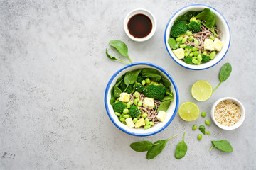 Vegan noodles with green vegetables and tofu Broccoli vegetables, edamame beans, spinach and sesame seeds