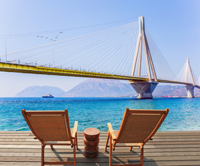 Fototapeta premium Two comfortable wooden loungers on the beach