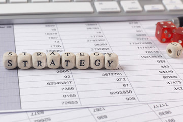 Fototapeta premium The strategy word on wood cube business content image.