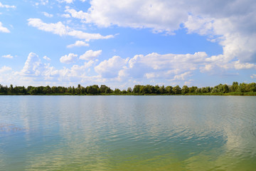 Fabulous beautiful view of the lake and forest green in nature. Summer landscape.
