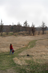 a woman with a child walking on a country road