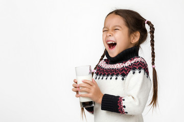 Portrait of happy cute little child girl holding glass of fresh milk isolated on white