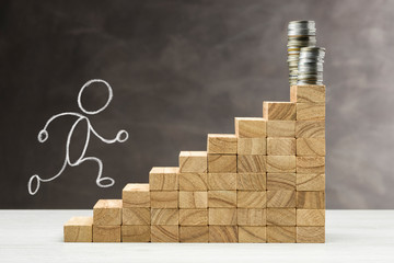 Concept of growth. Graphic with wooden steps on grey background with stack of coins on top and...