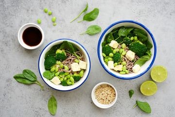 Vegan noodles with green vegetables and tofu Broccoli vegetables, edamame beans, spinach and sesame...