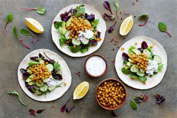 Vegan Tortilla Chickpea Avocado Salad Cucumber and Yogurt Sauce. Healthy clean eating food concept. Flat lay ingredient