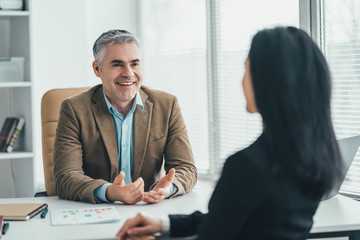 The two business people talking at the office table