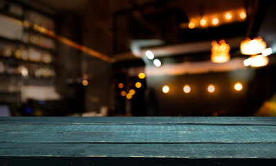 blurred background of bar and dark brown desk space of retro wood