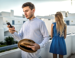 Young couple arguing, quarrel over phone. Girl offended, resentment, betrayal contradictions in...