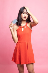 Young Asian woman headache with a blank card.