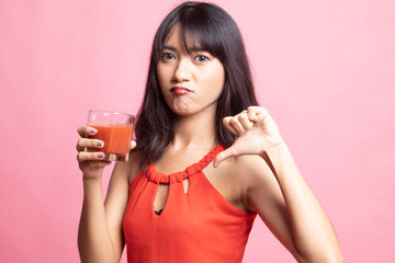 Asian woman thumbs down  hate tomato juice.