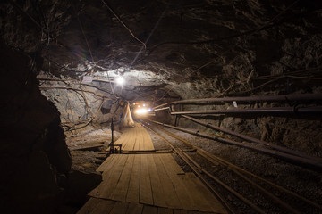 Naklejka premium Undeground gold mine tunnel drift with rails