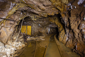 Undeground gold mine tunnel drift with rails