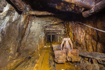 Fototapeta premium Undeground gold mine tunnel drift with rails