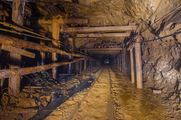 Underground gold mine tunnel drift with rails