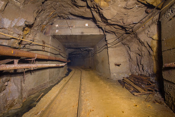 Fototapeta na wymiar Underground gold mine tunnel drift with rails
