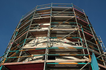 scaffolding around an old mill for restoration and reconstruction