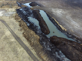 Stripping of a fertile layer of soil by excavator for sale. The land market in Ukraine.Drone aerial view. Near Kiev,Ukraine