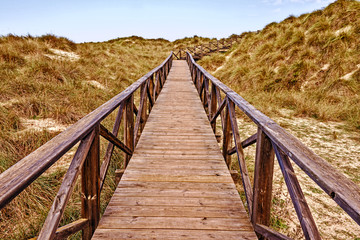Fototapeta na wymiar Wooden walkway with sea, sand dunes, cala mesquida, mallorca, spain.