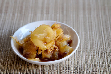 Sweet young coconut in sugar syrup in white dish, sweet dessert making from Thai local fruit, high sugar level that affect diabetes and  cause of many illness, and have space for write wording