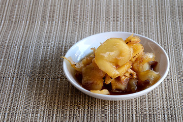 Sweet young coconut in sugar syrup in white dish, sweet dessert making from Thai local fruit, high sugar level that affect diabetes and  cause of many illness, and have space for write wording