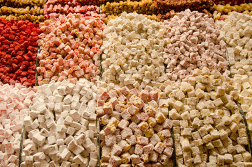background, close up of colorful  locum, sweet oriental delight in powered sugar on sale, Turkish sweets various locum, colorful sweets in Egyptian Bazaar or Spice Bazaar in Istanbul, Turkey 