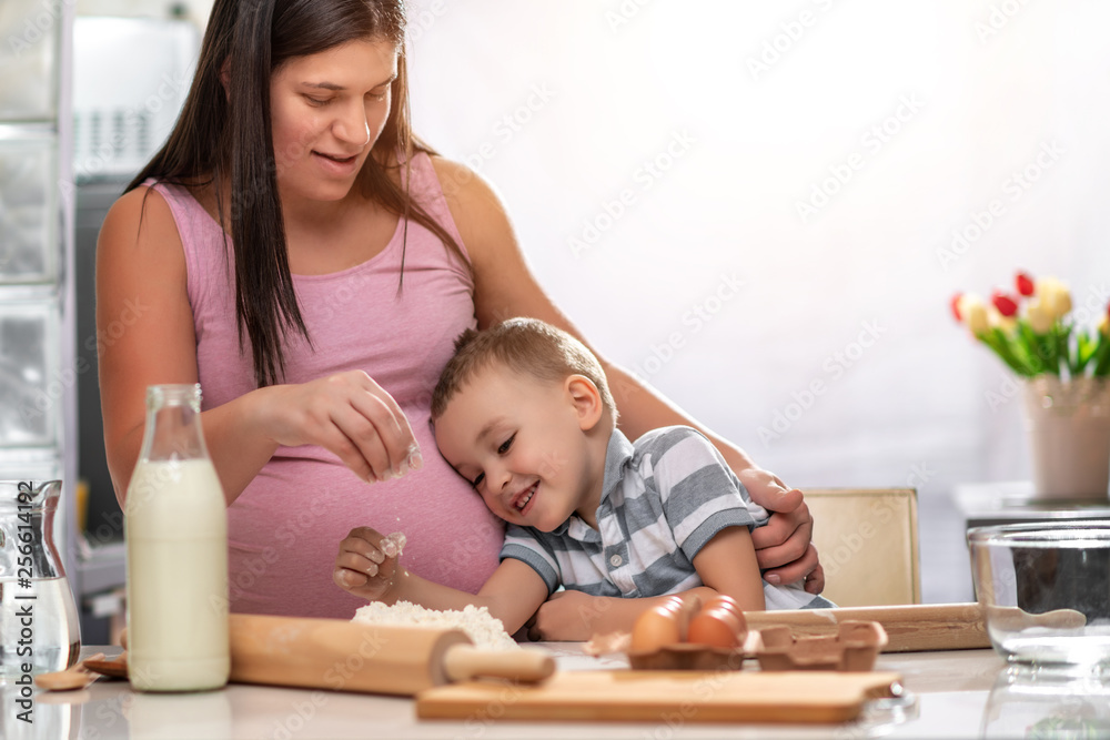 Poster Mother and son kneading dough in the kitchen