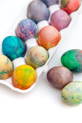 Group of Easter painted eggs in white container