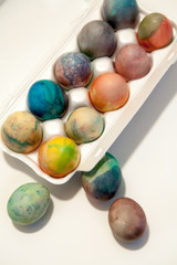 Group of Easter painted eggs in white container
