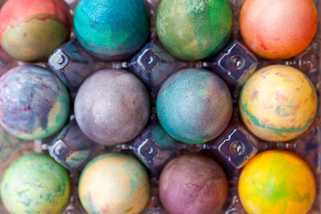 Group of Easter colored eggs in plastic container