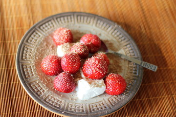 Strawberries with whipped cream and chocolate zest for Midsummer celebrations in Sweden.