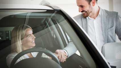 Portrait of happy customer buying new car