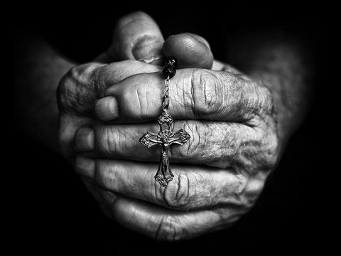 prayer hands with rosary